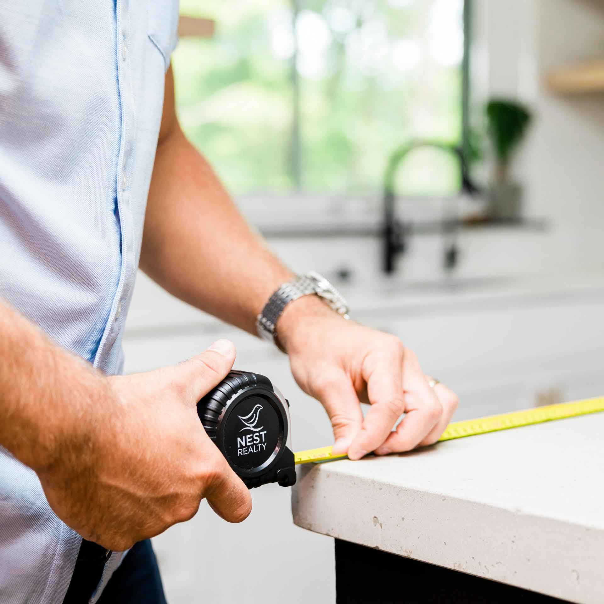 Nest tape measure being used to measure a countertop