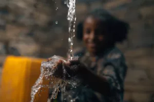 Image of girl catching water in her hands